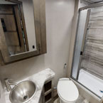 Bathroom with vanity, mirrored cabinet, toilet, and shower